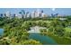 Stunning aerial view of a park with a pool, sports fields, and the city skyline, blending recreational and urban landscapes at 1058 Piedmont Ave # 103, Atlanta, GA 30309