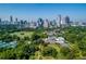 Expansive aerial view of a cityscape overlooking green spaces, tennis courts and building with unique design at 1058 Piedmont Ave # 103, Atlanta, GA 30309