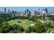Breathtaking aerial shot of a park with baseball fields and the city skyline, highlighting green spaces and urban views at 1058 Piedmont Ave # 103, Atlanta, GA 30309