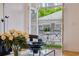 Living room view of balcony featuring gray chairs and table, outside greenery, and neighboring homes at 1058 Piedmont Ave # 103, Atlanta, GA 30309