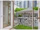 Cozy balcony featuring black railings, a small table with a plant, and faux grass, offering a charming outdoor space at 1058 Piedmont Ave # 103, Atlanta, GA 30309