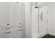 This modern bathroom features a glass-enclosed shower, stylish white tile, and storage cabinets at 1058 Piedmont Ave # 103, Atlanta, GA 30309