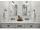 This bathroom features double sinks, marble countertops, and modern black fixtures at 1058 Piedmont Ave # 103, Atlanta, GA 30309