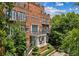 Beautiful brick building with elegant balconies, lush landscaping, and a grand entrance, showcasing classic architectural details at 1058 Piedmont Ave # 103, Atlanta, GA 30309