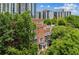 Scenic view of a brick building surrounded by mature trees with a city skyline backdrop, blending urban and natural elements at 1058 Piedmont Ave # 103, Atlanta, GA 30309