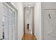 Bright hallway with wood floors, white walls, and a view into another room with light curtains at 1058 Piedmont Ave # 103, Atlanta, GA 30309