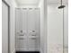 Hallway featuring a linen closet and walk-in shower with black tile floor at 1058 Piedmont Ave # 103, Atlanta, GA 30309