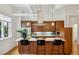 Spacious kitchen features wooden cabinets, stainless appliances, and an island with bar seating at 1058 Piedmont Ave # 103, Atlanta, GA 30309