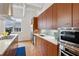 This kitchen includes stainless steel appliances, stylish cabinetry, and a breakfast bar counter at 1058 Piedmont Ave # 103, Atlanta, GA 30309