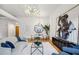 Living room with hardwood floors, abstract art, modern lighting and partial view of the modern kitchen at 1058 Piedmont Ave # 103, Atlanta, GA 30309