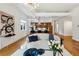 Stylishly furnished living room leading into the kitchen, featuring hardwood floors and modern finishes at 1058 Piedmont Ave # 103, Atlanta, GA 30309