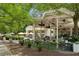 Charming Shake Shack restaurant with outdoor seating, string lights, and lush greenery, creating an inviting atmosphere at 1058 Piedmont Ave # 103, Atlanta, GA 30309