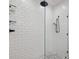 Close-up of a modern shower with white subway tile and glass enclosure at 1058 Piedmont Ave # 103, Atlanta, GA 30309