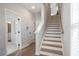 Hallway boasts hardwood floors, staircase, and access to a bathroom at 1895 Deco Dr, Kennesaw, GA 30144
