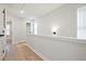 Hallway with natural light has wood floors and neutral paint color at 1895 Deco Dr, Kennesaw, GA 30144