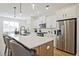 Modern kitchen boasts a large island, stainless steel appliances, and sleek white cabinetry at 1895 Deco Dr, Kennesaw, GA 30144
