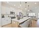 Bright kitchen with white cabinetry, large island and seating overlooking the living room at 1895 Deco Dr, Kennesaw, GA 30144