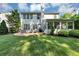 Spacious backyard with a patio, green lawn, and a variety of plants and shrubs at 338 Santa Anita Ave, Woodstock, GA 30189