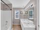 Well-lit bathroom featuring a double sink vanity and tiled floors at 338 Santa Anita Ave, Woodstock, GA 30189