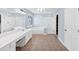 Bathroom featuring double vanities, walk in shower, and separate tub with a window at 338 Santa Anita Ave, Woodstock, GA 30189