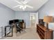 Bedroom with neutral carpet, a ceiling fan, and desk space; perfect for a home office setup at 338 Santa Anita Ave, Woodstock, GA 30189