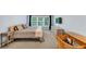 Bedroom featuring a large window, light wood furniture, and neutral carpeting for a calming space at 338 Santa Anita Ave, Woodstock, GA 30189