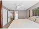 Spacious bedroom with a four-poster bed, ceiling fan, and a view to the landing at 338 Santa Anita Ave, Woodstock, GA 30189