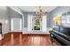 Well-lit dining room featuring hardwood floors, large window, and a piano at 338 Santa Anita Ave, Woodstock, GA 30189