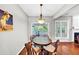 Dining room features hardwood floors, lots of windows, and decorative vintage wall art at 338 Santa Anita Ave, Woodstock, GA 30189