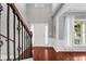 Bright foyer with hardwood floors, staircase, and view of the front porch through a window at 338 Santa Anita Ave, Woodstock, GA 30189
