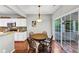 Open kitchen and dining room, hardwood floors, white cabinets and stainless steel appliances at 338 Santa Anita Ave, Woodstock, GA 30189