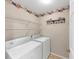 Functional laundry room with washer, dryer, and wire shelving for organized storage solutions at 338 Santa Anita Ave, Woodstock, GA 30189