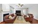Comfortable living room features a ceiling fan, fire place, and a large screen television at 338 Santa Anita Ave, Woodstock, GA 30189