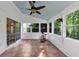 The light-filled sunroom features tiled floors and multiple windows to the green landscape outside at 338 Santa Anita Ave, Woodstock, GA 30189