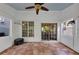 Sunny enclosed porch offers multiple windows, a tile floor, and a ceiling fan at 338 Santa Anita Ave, Woodstock, GA 30189