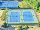 Two tennis courts in green and blue, lit for evening play at 338 Santa Anita Ave, Woodstock, GA 30189