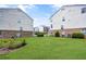 Well-maintained backyard lawn area between residential buildings, featuring green grass and minimal landscaping at 3788 Chattahoochee Summit Se Dr # 22, Atlanta, GA 30339