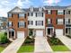 Charming townhome featuring brick facade, dormers, and well-manicured landscaping at 3788 Chattahoochee Summit Se Dr # 22, Atlanta, GA 30339