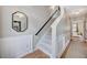 Welcoming hallway with staircase, wainscoting, mirror and hardwood floors at 3788 Chattahoochee Summit Se Dr # 22, Atlanta, GA 30339