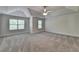Spacious bedroom featuring tray ceilings, neutral colors, plush carpet, and bright windows at 4095 Sierra Vista Cir, Cumming, GA 30040