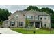 Stunning brick home with a well-manicured lawn and elegant architectural details at 4095 Sierra Vista Cir, Cumming, GA 30040