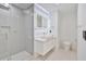 Modern bathroom features a sleek, illuminated mirror, glass shower and white tile at 507 Karen Ln, Woodstock, GA 30188