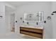 Bathroom featuring dual vessel sinks, illuminated vanity mirror, and modern fixtures at 507 Karen Ln, Woodstock, GA 30188