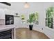 Bright breakfast nook features hardwood floors and multiple windows overlooking wooded area at 507 Karen Ln, Woodstock, GA 30188
