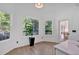 Bright breakfast nook features hardwood floors and multiple windows overlooking wooded area at 507 Karen Ln, Woodstock, GA 30188