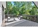 Outdoor deck features modern seating and a stylish rug, surrounded by lush greenery at 507 Karen Ln, Woodstock, GA 30188