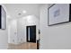 Stylish entryway boasting a modern black door with light hardwood flooring and contemporary artwork at 507 Karen Ln, Woodstock, GA 30188