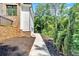 Stone and white siding home exterior with a concrete path and lush greenery at 507 Karen Ln, Woodstock, GA 30188