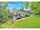 Stunning home boasts a deck, lush landscaping, and modern architectural design set on a serene, wooded lot at 507 Karen Ln, Woodstock, GA 30188