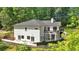 Rear exterior showcasing a modern home design with a private balcony and a walkout basement at 507 Karen Ln, Woodstock, GA 30188